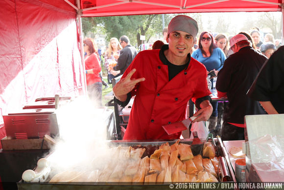 Steven Sullivan, owner of SHAVE 'N FLAV catering, preparing hot tamales on the grill .