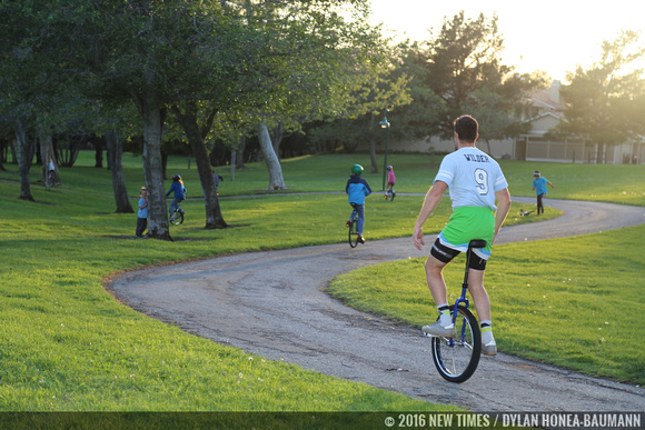 Mark Wilder and the kids unicycle down the path at Meadow Park.