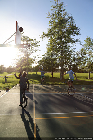 Unicycle aficionados practice as the sun goes down at Meadow Park.