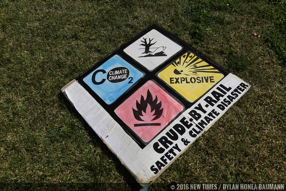 Activists created custom signs to show why they are against oil trains.