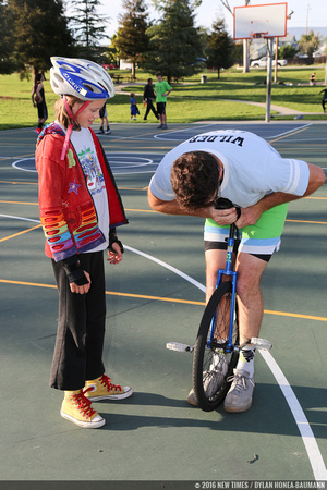 Mark Wilder adjusts a unicycle for a student.