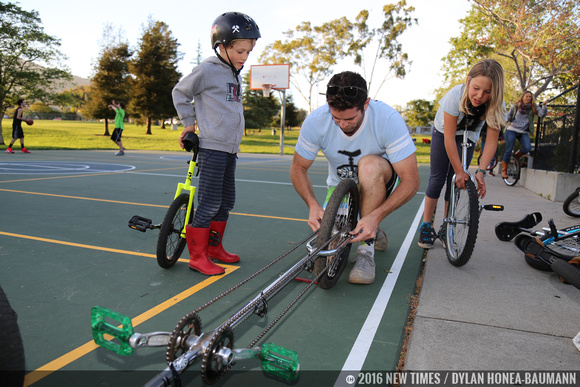 Mark Wilder adjust a unicycle during practice at Meadow Park.