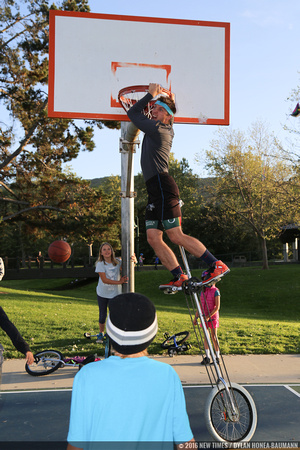 VonJon gets a slam dunk while riding a 7-foot tall unicycle.
